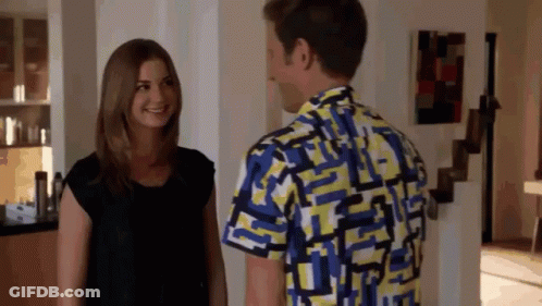 Man In Colorful Shirt Talks To Woman GIF