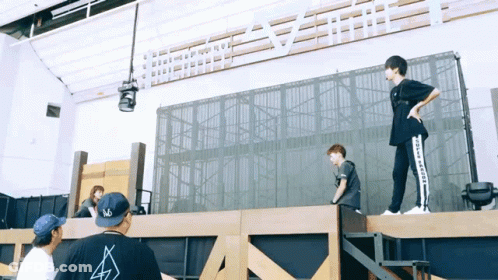 Man In Converse Shirt On Wooden Platform GIF