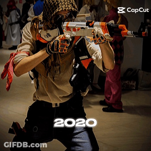 Man In Costume Holding Gun With Year 2020 Below GIF