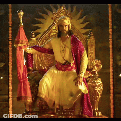 Man In Costume On Throne With Sun GIF