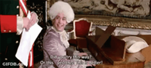 Man In Costume Playing Piano Talking To Another Man GIF