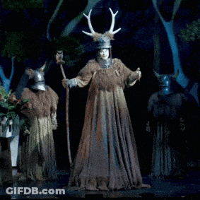 Man In Costume With Antlers Standing Next To Another Man GIF