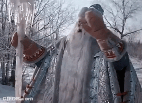 Man In Costume With Beard Holding Ice Wand In Snow GIF