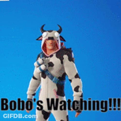 Man In Cow Costume Next To Monkey With Bananas On Head GIF