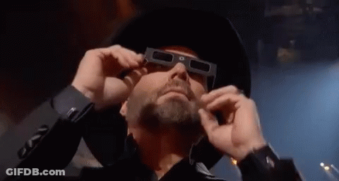 Man In Cowboy Hat And 3D Glasses Looking GIF