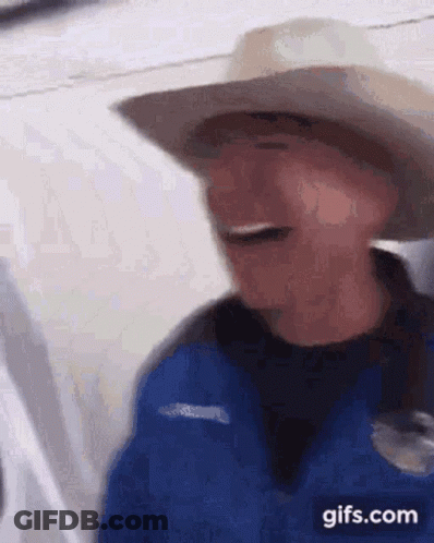Man In Cowboy Hat And Blue Jacket Laughing On Plane GIF