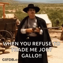 Man In Cowboy Hat And Cape Holding Gun GIF