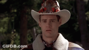 Man In Cowboy Hat And Gloves Looking At Camera GIF