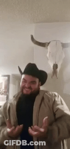 Man In Cowboy Hat And Jacket With Cow Skull GIF