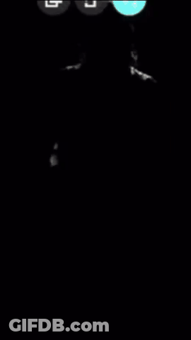 Man In Cowboy Hat And Plaid Shirt Standing In Dark GIF