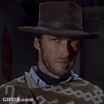 Man In Cowboy Hat And Poncho Blowing Bubbles GIF