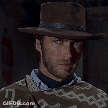 Man In Cowboy Hat And Poncho Blowing Bubbles GIF