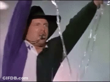 Man In Cowboy Hat And Purple Jacket Holding Rope GIF