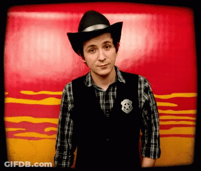 Man In Cowboy Hat And Sheriff Vest GIF