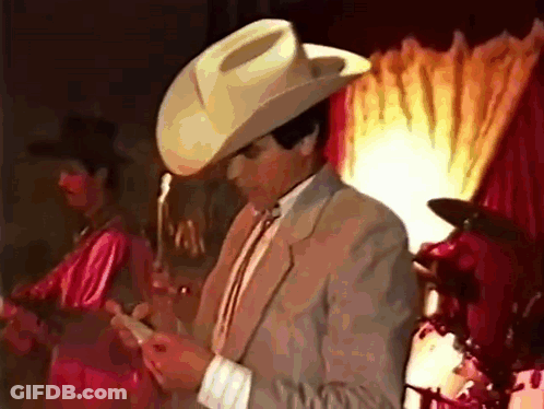 Man In Cowboy Hat And Suit On Phone GIF