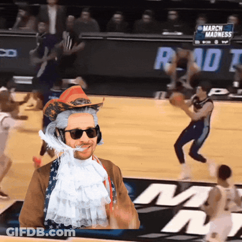 Man In Cowboy Hat And Sunglasses At March Madness Sign GIF