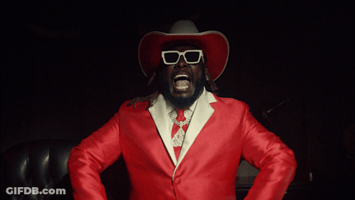 Man In Cowboy Hat And Sunglasses Holding Guns GIF