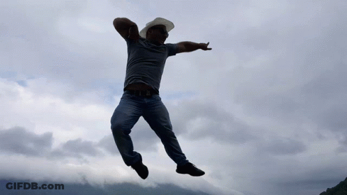 Man In Cowboy Hat And Sunglasses Jumping GIF