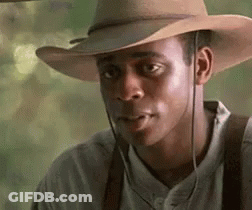 Man In Cowboy Hat And Suspenders Looking Sideways GIF