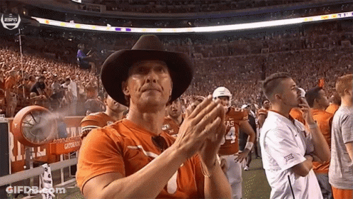 Man In Cowboy Hat And Texas Shirt Clapping GIF