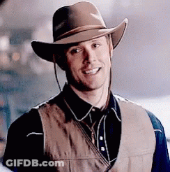Man In Cowboy Hat And Vest Smiling GIF