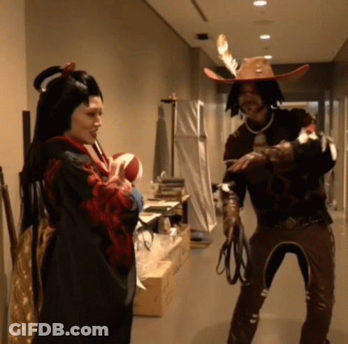 Man In Cowboy Hat And Woman In Kimono Standing In Hallway GIF