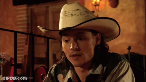 Man In Cowboy Hat At Table GIF