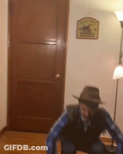 Man In Cowboy Hat At Wooden Door With Wild West Sign GIF