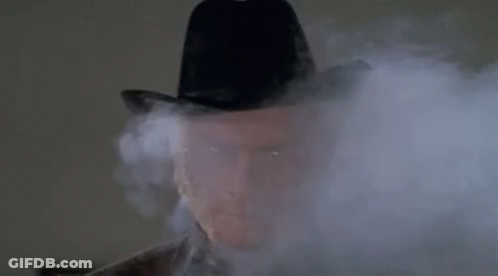 Man In Cowboy Hat Covered In Smoke GIF