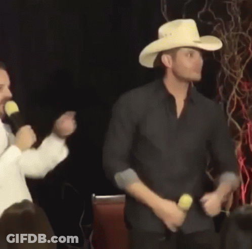 Man In Cowboy Hat Dancing In Front Of Microphone GIF