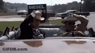 Man In Cowboy Hat Driving Beside Diesel Sign GIF