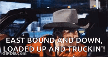 Man In Cowboy Hat Driving Car East Bound And Down Loaded Up And Truckin GIF