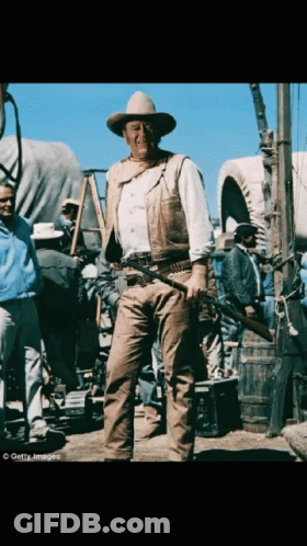 Man In Cowboy Hat Holding Gun GIF