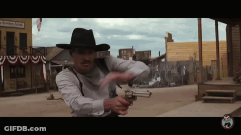 Man In Cowboy Hat Holding Gun In Front Of A Smoking Room GIF