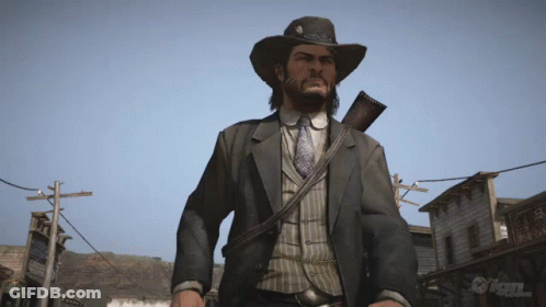 Man In Cowboy Hat Holding Gun In Front Of IGN Sign GIF