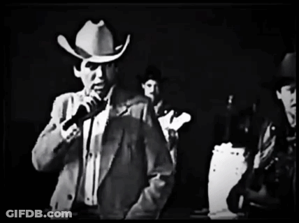 Man In Cowboy Hat Holding Microphone GIF