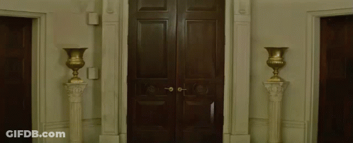 Man In Cowboy Hat Holding Umbrella Walking Through Doorway GIF