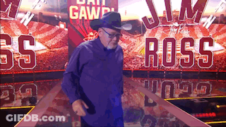 Man In Cowboy Hat In Front Of Jim Ross Sign GIF