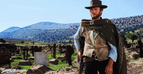 Man In Cowboy Hat In Graveyard GIF