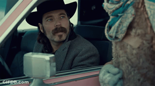 Man In Cowboy Hat Looking Out Pink Car Window GIF