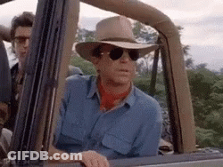 Man In Cowboy Hat Lying On Dinosaur GIF