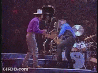 Man In Cowboy Hat Next To Woman In Blue Shirt GIF