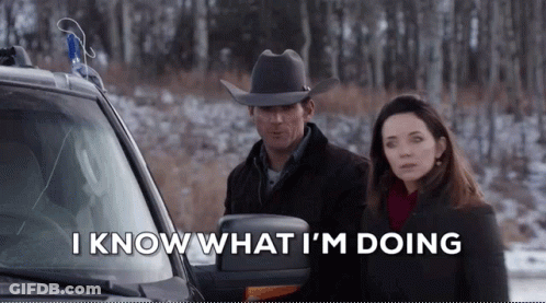 Man In Cowboy Hat Next To Woman In Snowy Forest GIF