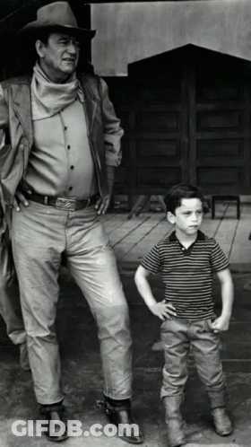 Man In Cowboy Hat Next To Young Boy GIF