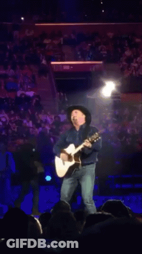 Man In Cowboy Hat Playing Guitar For Crowd GIF