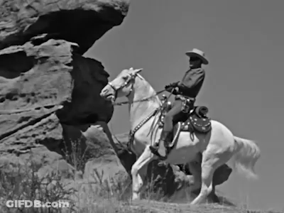 Man In Cowboy Hat Riding Horse On Rocky Hillside GIF