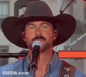 Man In Cowboy Hat Singing Into Microphone GIF