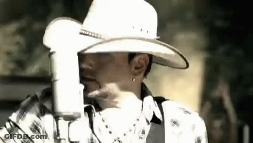 Man In Cowboy Hat Singing Into Microphone GIF
