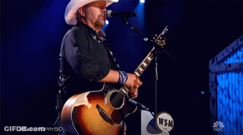 Man In Cowboy Hat Singing Into Microphone #Dolly Opry50 GIF
