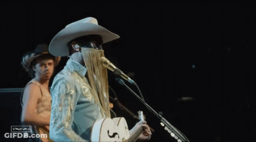 Man In Cowboy Hat Singing Into Microphone GIF
